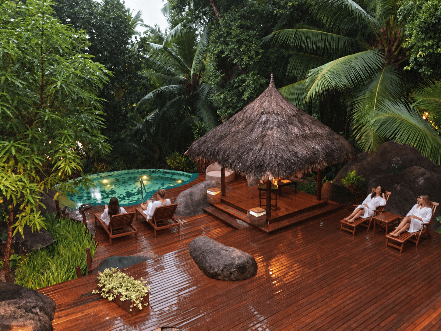A wellness retreat deck surrounded by tropical greenery